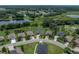 Aerial view of a single Gathering home nestled amongst trees and ponds in a desirable community, providing a peaceful retreat at 34652 Heavenly Ln, Dade City, FL 33525