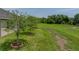 Well-maintained backyard with lush green grass and newly planted trees in the landscaping at 34652 Heavenly Ln, Dade City, FL 33525