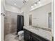 Clean bathroom featuring gray tile and granite countertop vanity at 34652 Heavenly Ln, Dade City, FL 33525