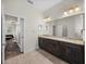 This bathroom features dual sinks with granite countertops, tile floor, and ample storage at 34652 Heavenly Ln, Dade City, FL 33525