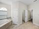 This bathroom features a soaking tub, a walk-in closet, and neutral paint at 34652 Heavenly Ln, Dade City, FL 33525