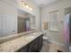 Bathroom featuring granite counters, neutral tile, and a shower-tub combination at 34652 Heavenly Ln, Dade City, FL 33525