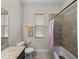Neutral bathroom with tiled shower-tub combination, granite counters, and natural light at 34652 Heavenly Ln, Dade City, FL 33525
