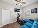 Bedroom features a ceiling fan, closet, mounted TV, and an exercise machine at 34652 Heavenly Ln, Dade City, FL 33525