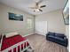 Bedroom features wood floors, a ceiling fan, a closet, and a mounted TV at 34652 Heavenly Ln, Dade City, FL 33525