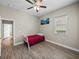 Bedroom with wood floors and a ceiling fan, offering comfortable and stylish living at 34652 Heavenly Ln, Dade City, FL 33525