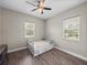 Bright bedroom featuring wood floors, a ceiling fan, and a window offering natural light at 34652 Heavenly Ln, Dade City, FL 33525