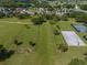 Aerial view of the community park with tennis courts, basketball court, and open green space at 34652 Heavenly Ln, Dade City, FL 33525