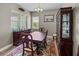 A dining room with wood floors, a window, and a china cabinet at 34652 Heavenly Ln, Dade City, FL 33525
