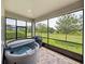 Covered hot tub on the screened lanai, with backyard and nature views at 34652 Heavenly Ln, Dade City, FL 33525