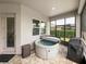 Outdoor hot tub on a screened lanai, perfect for relaxation and entertaining at 34652 Heavenly Ln, Dade City, FL 33525