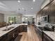Open kitchen featuring granite countertops, stainless steel appliances, and wood flooring at 34652 Heavenly Ln, Dade City, FL 33525