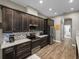Well-equipped kitchen features stainless steel appliances, mosaic backsplash, and sleek cabinetry at 34652 Heavenly Ln, Dade City, FL 33525