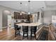 Kitchen features stylish stools along the granite counter, stainless steel appliances, and hardwood floors at 34652 Heavenly Ln, Dade City, FL 33525