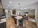 Open kitchen with counter seating offering views of the living room and modern appliances at 34652 Heavenly Ln, Dade City, FL 33525