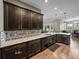 This kitchen features wooden cabinetry, granite countertops, and stainless steel appliances at 34652 Heavenly Ln, Dade City, FL 33525