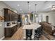 Gourmet kitchen with pendant lighting, granite counters, stainless steel appliances, and hardwood floors at 34652 Heavenly Ln, Dade City, FL 33525