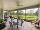 Relaxing screened lanai with outdoor furniture and views of the backyard at 34652 Heavenly Ln, Dade City, FL 33525