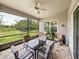 Charming screened lanai with a seating area and expansive green view at 34652 Heavenly Ln, Dade City, FL 33525