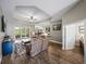 Spacious living room featuring hardwood floors, a ceiling fan, and sliding glass doors leading to the patio at 34652 Heavenly Ln, Dade City, FL 33525