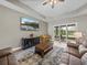 Inviting living room features a coffered ceiling, cozy seating, and a sliding door to the outdoor patio at 34652 Heavenly Ln, Dade City, FL 33525