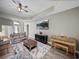 Bright living room with coffered ceilings, a large screen tv and elegant furniture at 34652 Heavenly Ln, Dade City, FL 33525