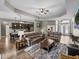 Open concept living room and kitchen featuring hardwood floors, ceiling fan and stylish furnishings at 34652 Heavenly Ln, Dade City, FL 33525