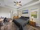 This main bedroom offers a ceiling fan, ample natural light, and neutral décor at 34652 Heavenly Ln, Dade City, FL 33525
