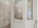 This walk-in shower features frameless glass, a built-in bench, and dual shower heads at 34652 Heavenly Ln, Dade City, FL 33525