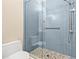 Bathroom shower featuring blue tile and a clear glass door with modern fixtures at 3512 Tealwood Cir, Palm Harbor, FL 34685