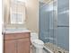 Bathroom with an updated vanity, toilet, and tiled shower with a glass door at 3512 Tealwood Cir, Palm Harbor, FL 34685