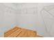 Walk-in closet with wood floors and wire shelving at 3512 Tealwood Cir, Palm Harbor, FL 34685