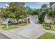 Attractive single-story house with a well-kept lawn, beautiful tree, and attached garage at 3512 Tealwood Cir, Palm Harbor, FL 34685