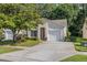 Charming single-story home with a well-manicured lawn, mature tree, and attached garage at 3512 Tealwood Cir, Palm Harbor, FL 34685
