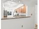 Kitchen view with granite countertops, tiled backsplash, stainless steel appliances, and wood cabinets at 3512 Tealwood Cir, Palm Harbor, FL 34685