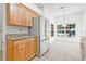 Bright eat-in kitchen featuring stainless steel appliances, stone countertops, and wooden cabinets at 3512 Tealwood Cir, Palm Harbor, FL 34685