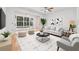 Modern living room with neutral decor and sliding glass doors to the backyard at 3512 Tealwood Cir, Palm Harbor, FL 34685
