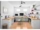 Contemporary office featuring a U-shaped desk with ample storage and a modern ceiling fan at 3512 Tealwood Cir, Palm Harbor, FL 34685