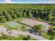 Recreational amenities featuring tennis and basketball courts, playground, and scenic lake views at 3512 Tealwood Cir, Palm Harbor, FL 34685