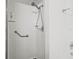 White tiled walk-in shower with safety grab bars at 3512 Tealwood Cir, Palm Harbor, FL 34685