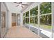 Sunroom with tile flooring and sliding glass doors that lead to the yard at 3512 Tealwood Cir, Palm Harbor, FL 34685