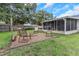 Large backyard features firepit and seating, a covered back porch, and a fully fenced perimeter at 3547 55Th N St, St Petersburg, FL 33710