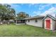 Exterior shot of backyard with a lush lawn, shed, firepit, and screened in porch at 3547 55Th N St, St Petersburg, FL 33710