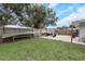 Spacious backyard with a grass lawn and gravel area for boat trailer at 3547 55Th N St, St Petersburg, FL 33710