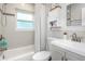 Bathroom features modern sink, updated fixtures, white tile, and a shower-tub combo at 3547 55Th N St, St Petersburg, FL 33710