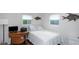 Bright bedroom featuring a bed, desk, and windows allowing ample natural light at 3547 55Th N St, St Petersburg, FL 33710