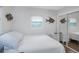 Bedroom featuring a bed, mirrored closet, and windows allowing ample natural light at 3547 55Th N St, St Petersburg, FL 33710