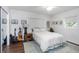 Comfortable bedroom with a queen-sized bed, hardwood floors, and a ceiling fan at 3547 55Th N St, St Petersburg, FL 33710