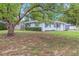 Quaint single-story home with inviting curb appeal, landscaped with mature trees and vibrant green shrubbery at 3547 55Th N St, St Petersburg, FL 33710