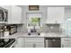 Stylish kitchen with a stainless steel sink, marble countertops, and subway tile backsplash at 3547 55Th N St, St Petersburg, FL 33710